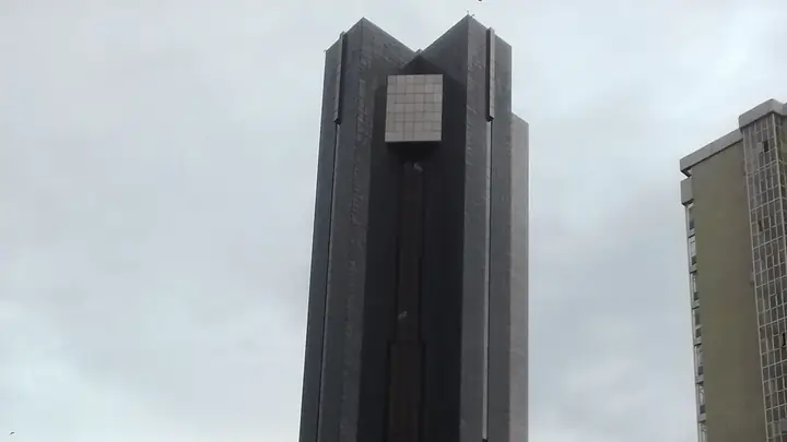 The South African Reserve Bank's dark glass head office tower in Pretoria against an overcast sky