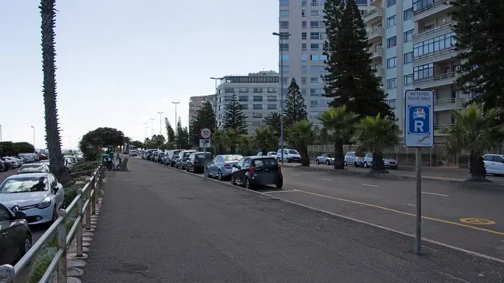 Apartment blocks and parked cars along Beach Road in Sea Point, Cape Town
